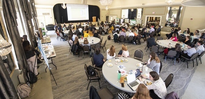 Large group of people watching a presentation